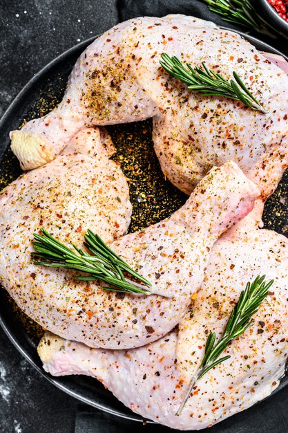 Raw chicken drumsticks with thighs, fresh herbs, cooking. Top view