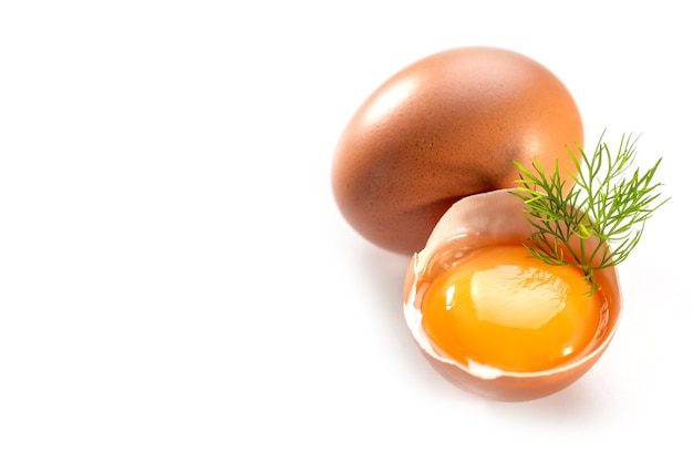 Photo raw chicken egg yolk in shell on white background