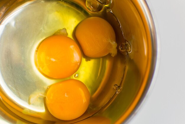 Raw chicken eggs in a metal bowl