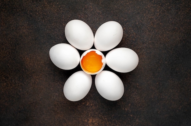 Raw chicken eggs on a stone table