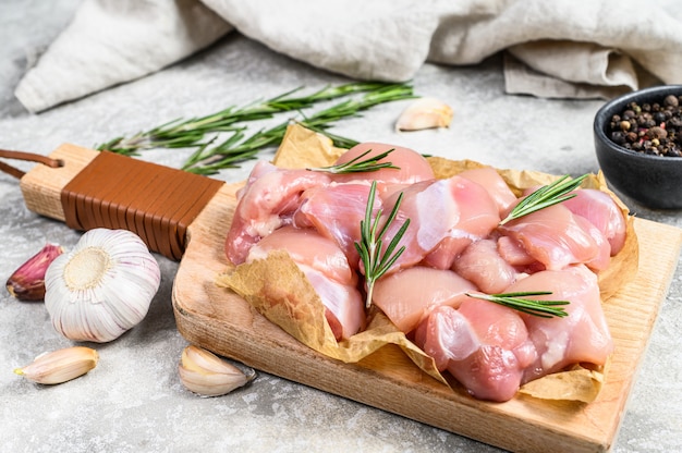 Raw chicken fillet cut into cubes with spices. Top view