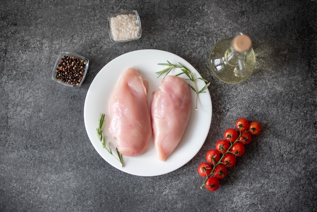 Raw chicken fillet on stone background