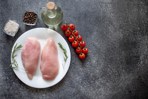 Raw chicken fillet on stone background