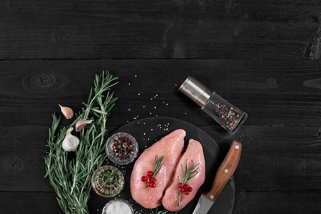 Raw chicken fillet with cooking ingredients on black slate table Food background Top view copy space Still life Flat lay