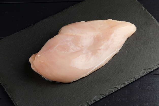 Raw chicken fillet wood board top view Fresh chicken breast with herbs and spices