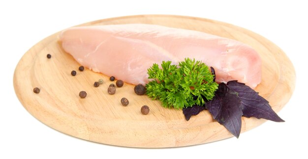 Raw chicken fillets on wooden board isolated on white