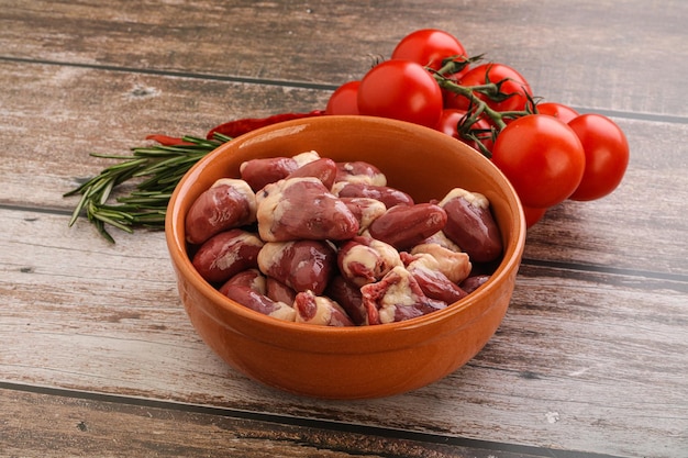 Raw chicken hearts for cooking served rosemary