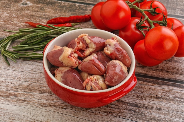 Raw chicken hearts for cooking served rosemary