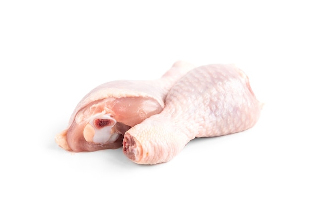 Raw chicken leg isolated on white surface.