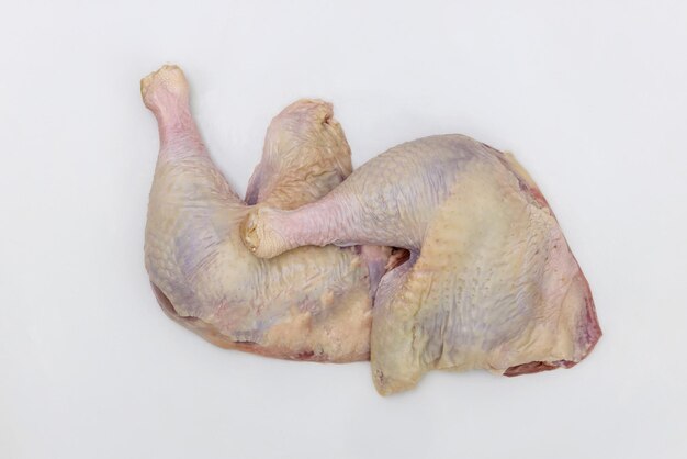 Raw chicken leg quarters on an isolated white background