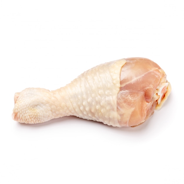 Raw chicken leg on a white isolated