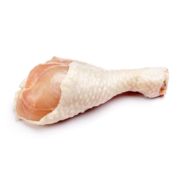 Raw chicken leg on a white isolated