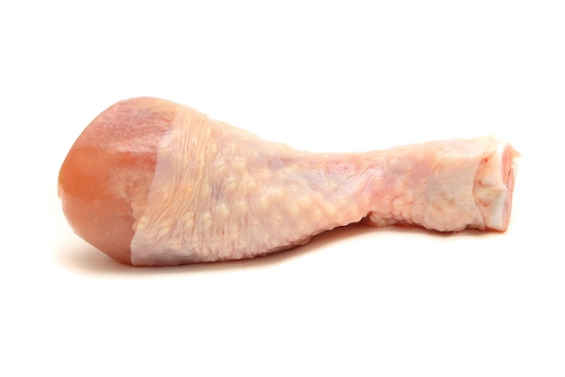 Raw chicken leg on white