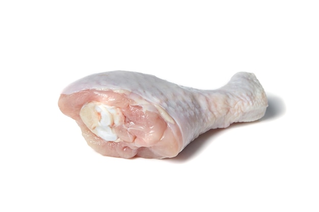 Raw chicken leg with skin Uncooked poultry meat isolated on white background