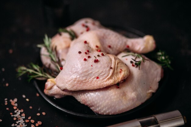 raw chicken legs on a dark background