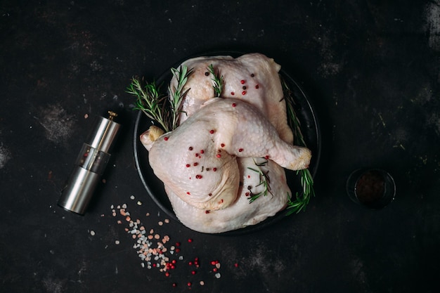 raw chicken legs on a dark background