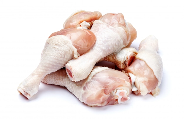 Raw chicken legs on a white isolated