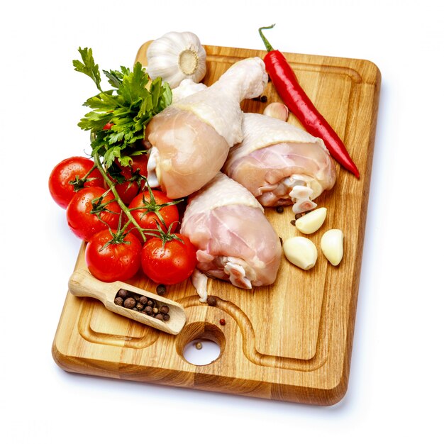 Raw chicken legs on a white isolated