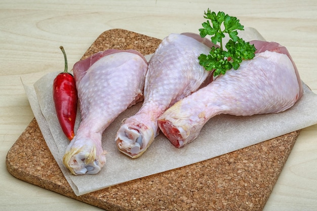 Raw chicken legs with parsley ready for cooking