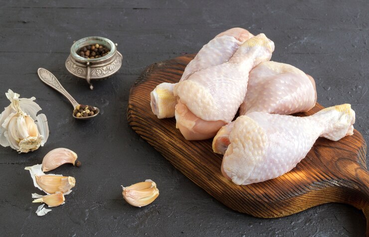 Raw chicken legs with spices. ingredients for cooking.