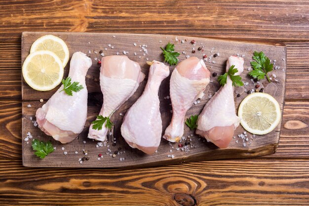 Raw chicken legs with spices and parsley Food background