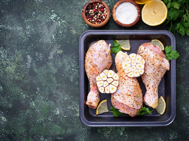 Raw chicken legs with spices ready for cooking