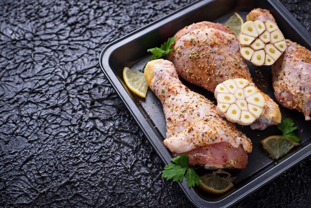 Raw chicken legs with spices ready for cooking