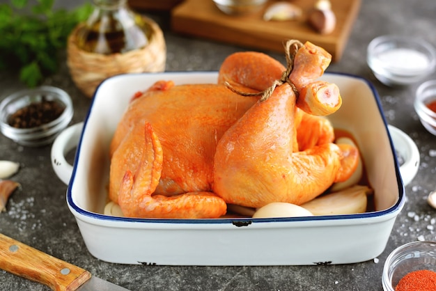 Raw chicken marinated in spices with turmeric and paprika