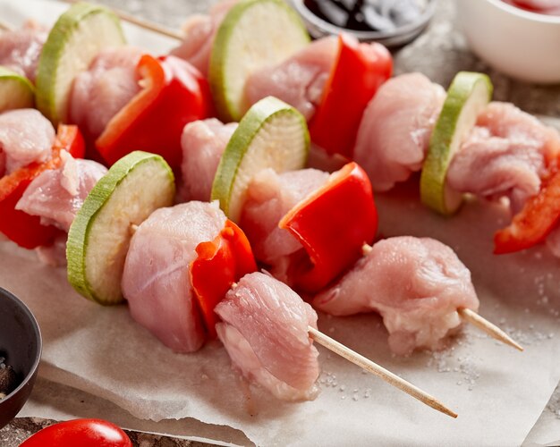 Raw chicken meat shashlik. wooden skewers with pepper and Zucchini