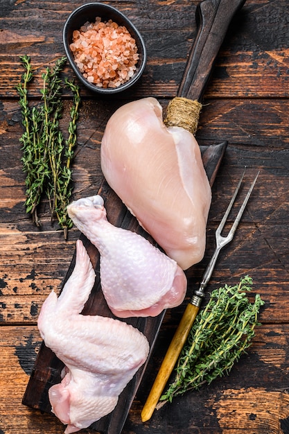 Raw chicken portions for cooking and barbecuing with skinless breasts, drumstick and wings.