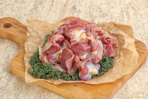 Raw chicken stomach for cooking over board