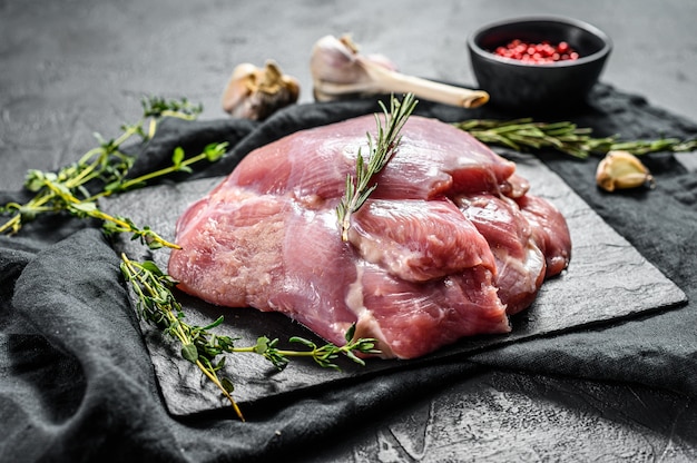 Raw chicken thigh fillet. farm eco meat. dark background. top\
view.