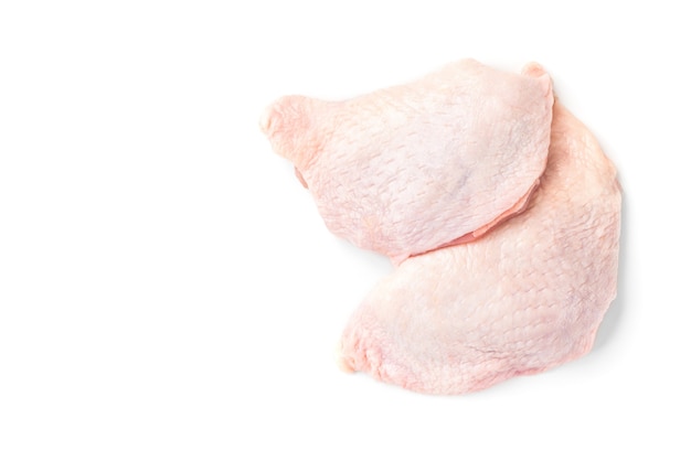 Raw chicken thighs isolated on white surface.