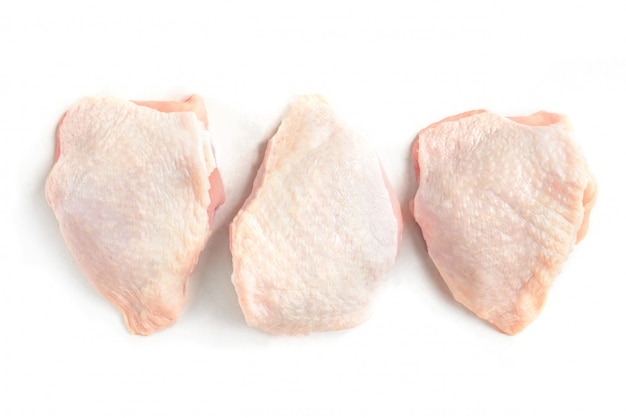 Raw chicken thighs isolated on white