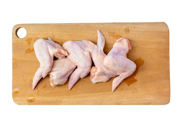 Raw chicken wings on cutting board isolated on white background with clipping path