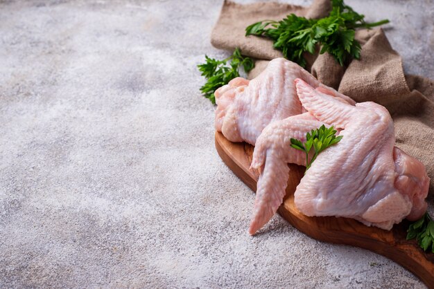 Raw chicken wings on cutting board