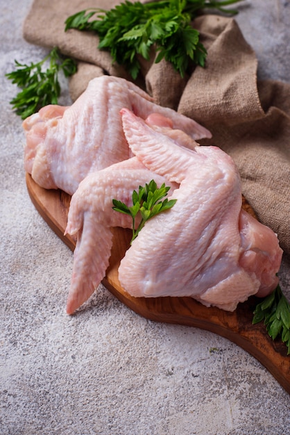 Raw chicken wings on cutting board