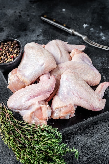 Raw chicken wings Poultry meat on a marble board.