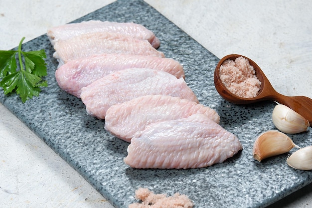 raw chicken wings on white background