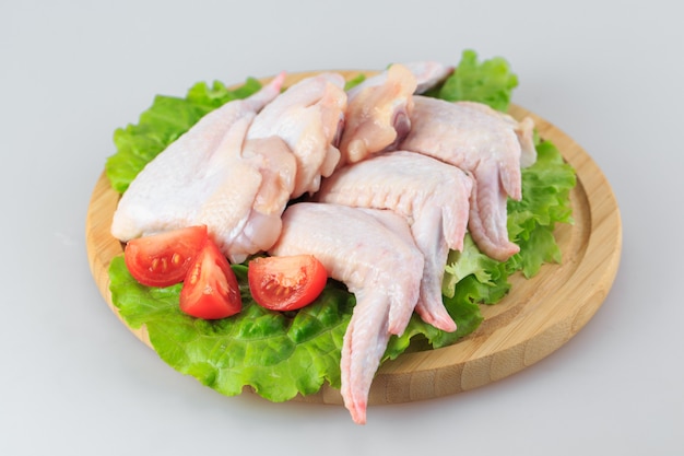 Raw chicken wings on white