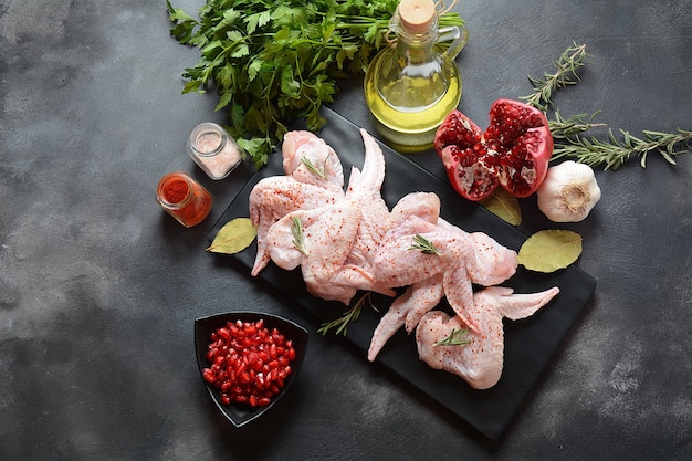 Raw chicken wings with ingredients for cooking