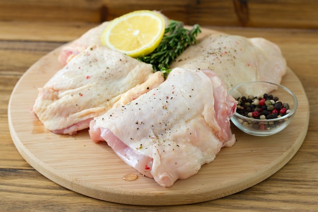 Raw chicken with lemon and pepper