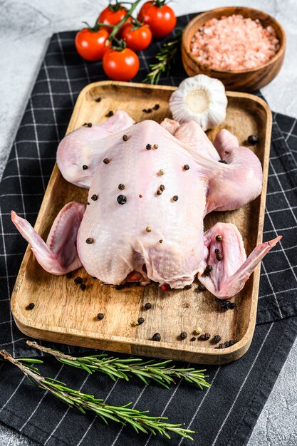 Raw chicken with rosemary and pepper