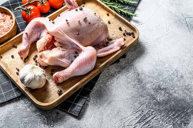 Raw chicken with rosemary and pepper