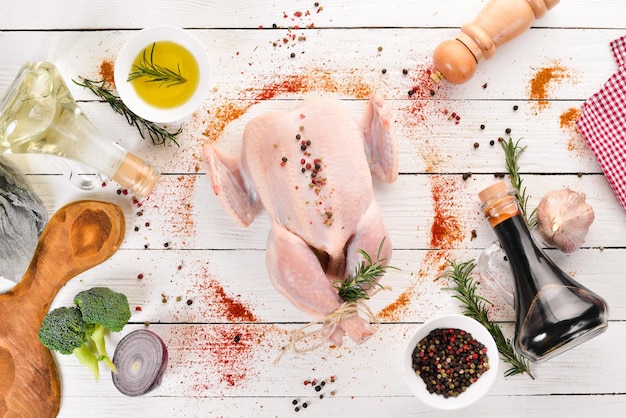 Raw chicken with vegetables and spices Barbecue On a white wooden background Top view Free copy space