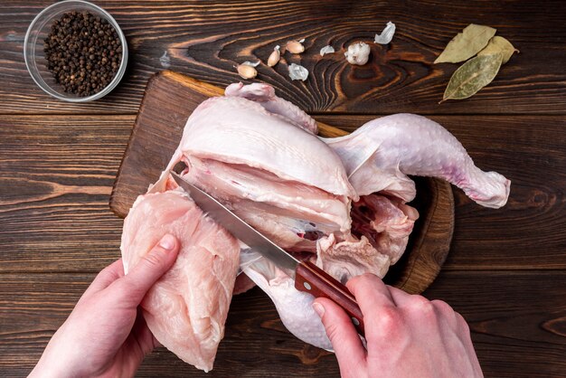 Raw chicken on wooden background with spices.