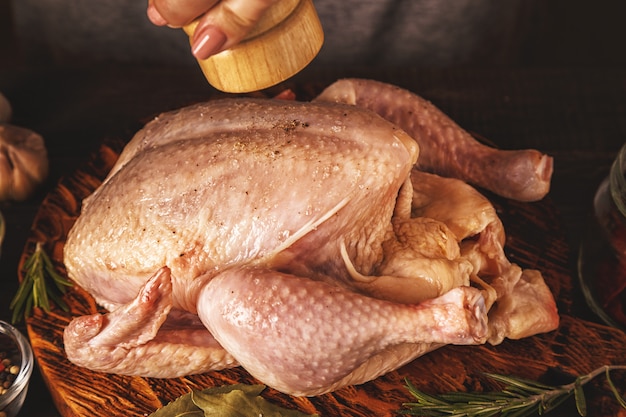 Raw chicken on a wooden cutting board