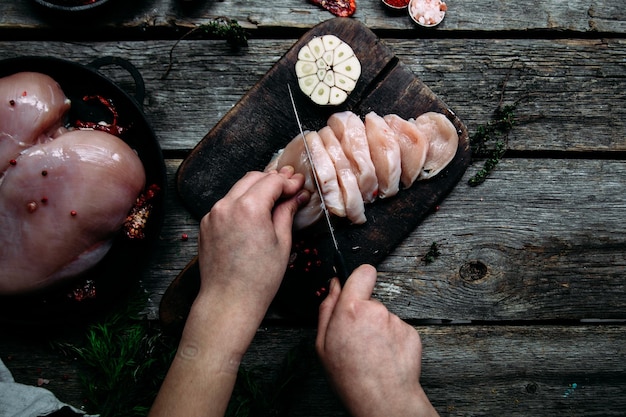 Raw chicken on a wooden table with spices