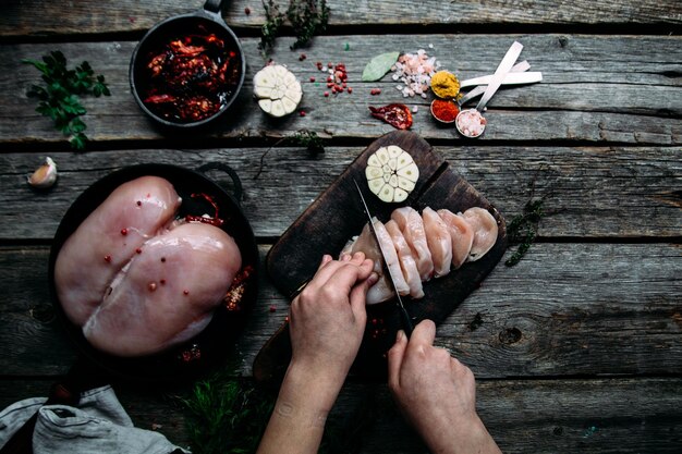 Raw chicken on a wooden table with spices