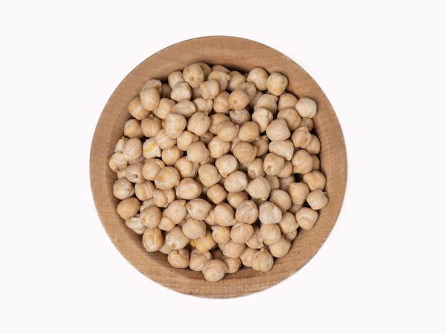 Raw chickpeas in wooden bowl on isolated white background